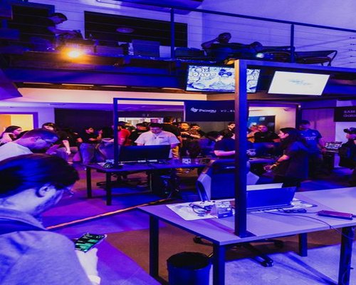 Panoramic gaming technology exhibition with monitors, consoles and event displays